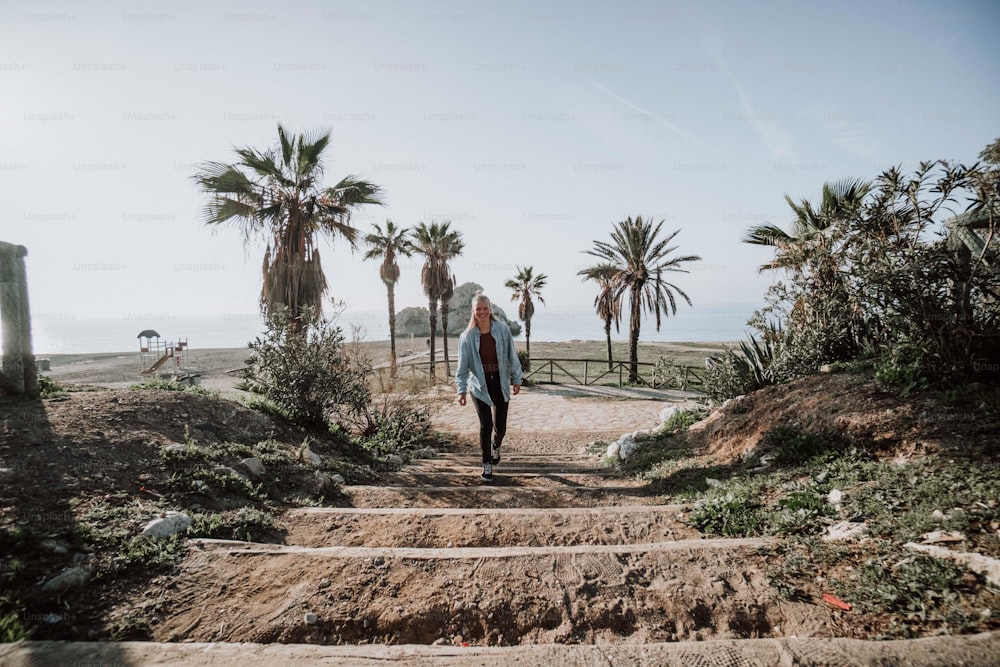 a woman walking down a set of stairs