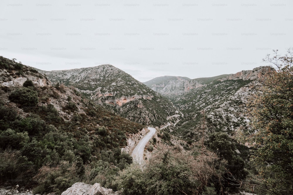 a winding road in the middle of a mountain range