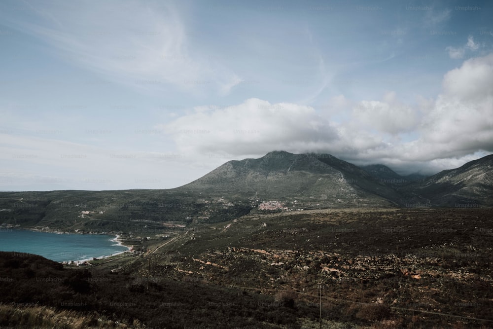 a scenic view of a mountain and a body of water