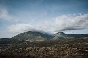 a view of a mountain range with clouds in the sky