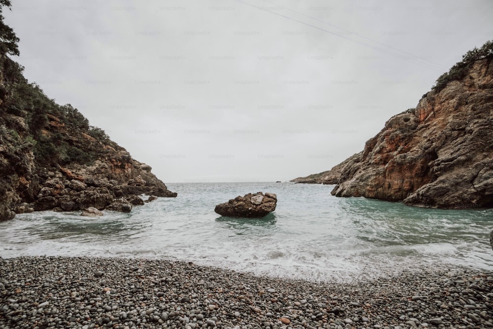 a body of water near a rocky shore
