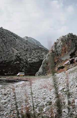 a van is parked in the snow near a mountain