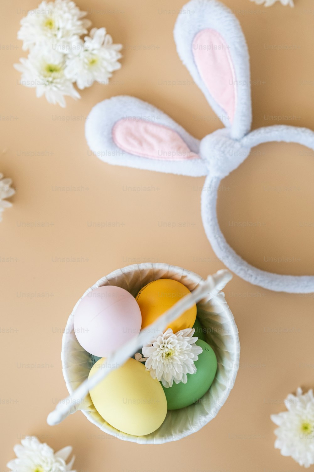 a bowl filled with eggs and a pair of bunny ears