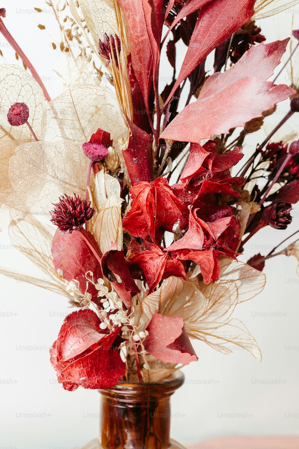 un vase rempli de fleurs rouges sur une table