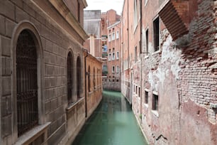 a narrow canal running between two buildings in a city