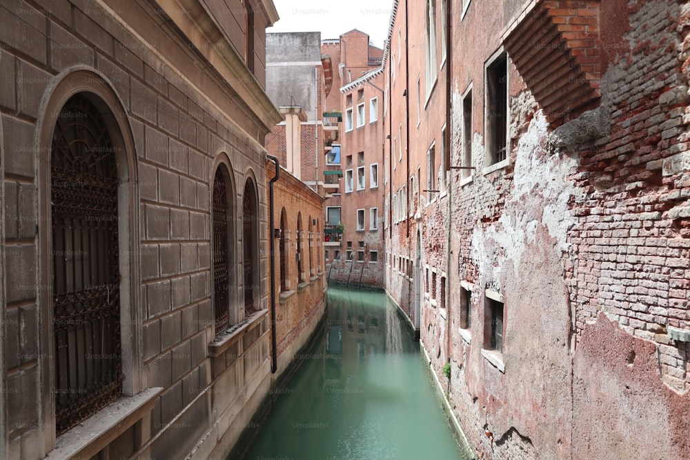 a narrow canal running between two buildings in a city