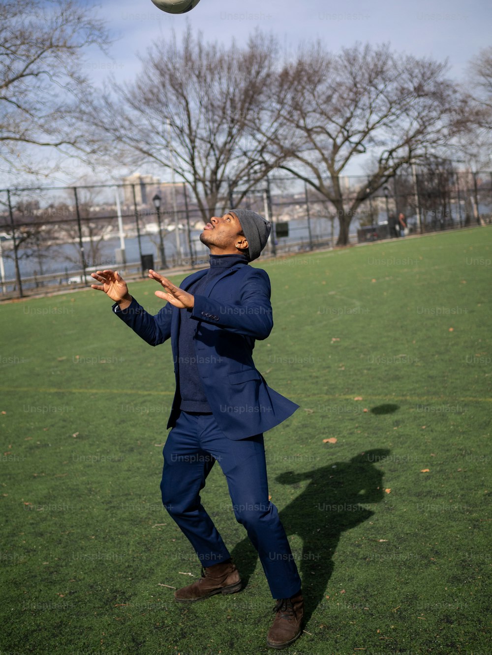 a man in a blue suit is playing frisbee