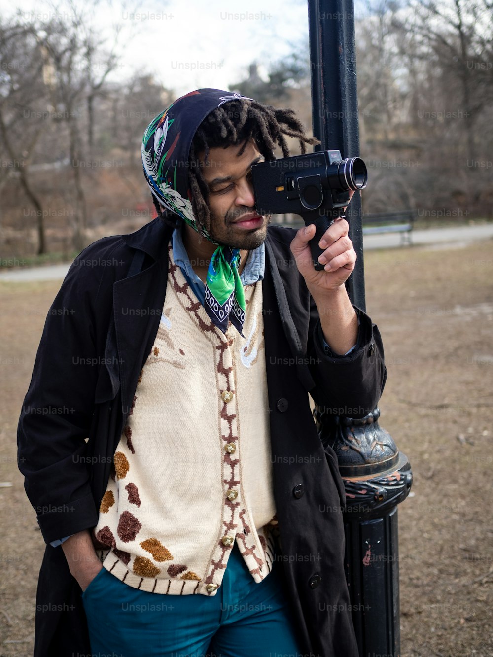 a man with dreadlocks is holding a camera