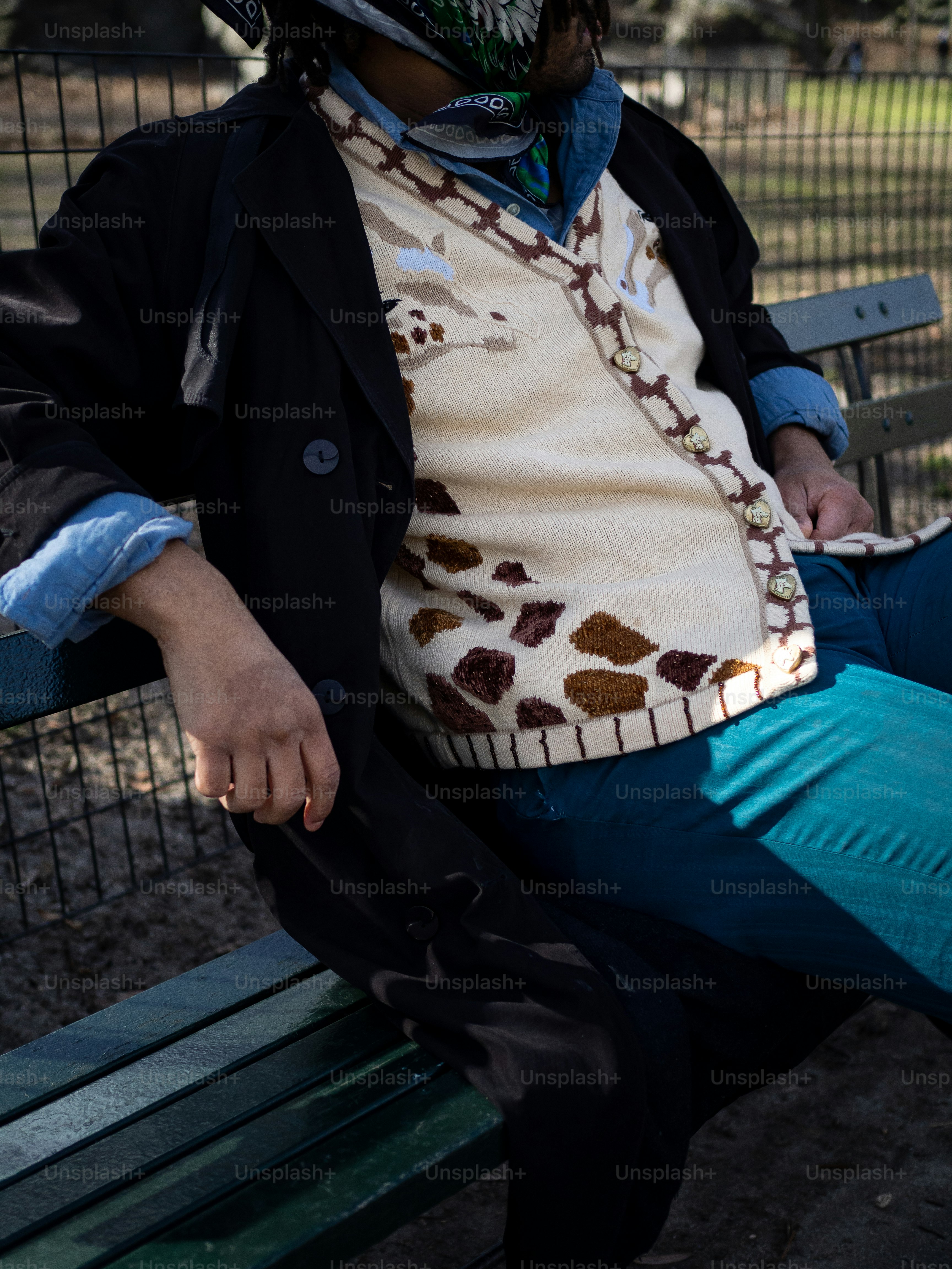 a man sitting on a bench wearing a helmet