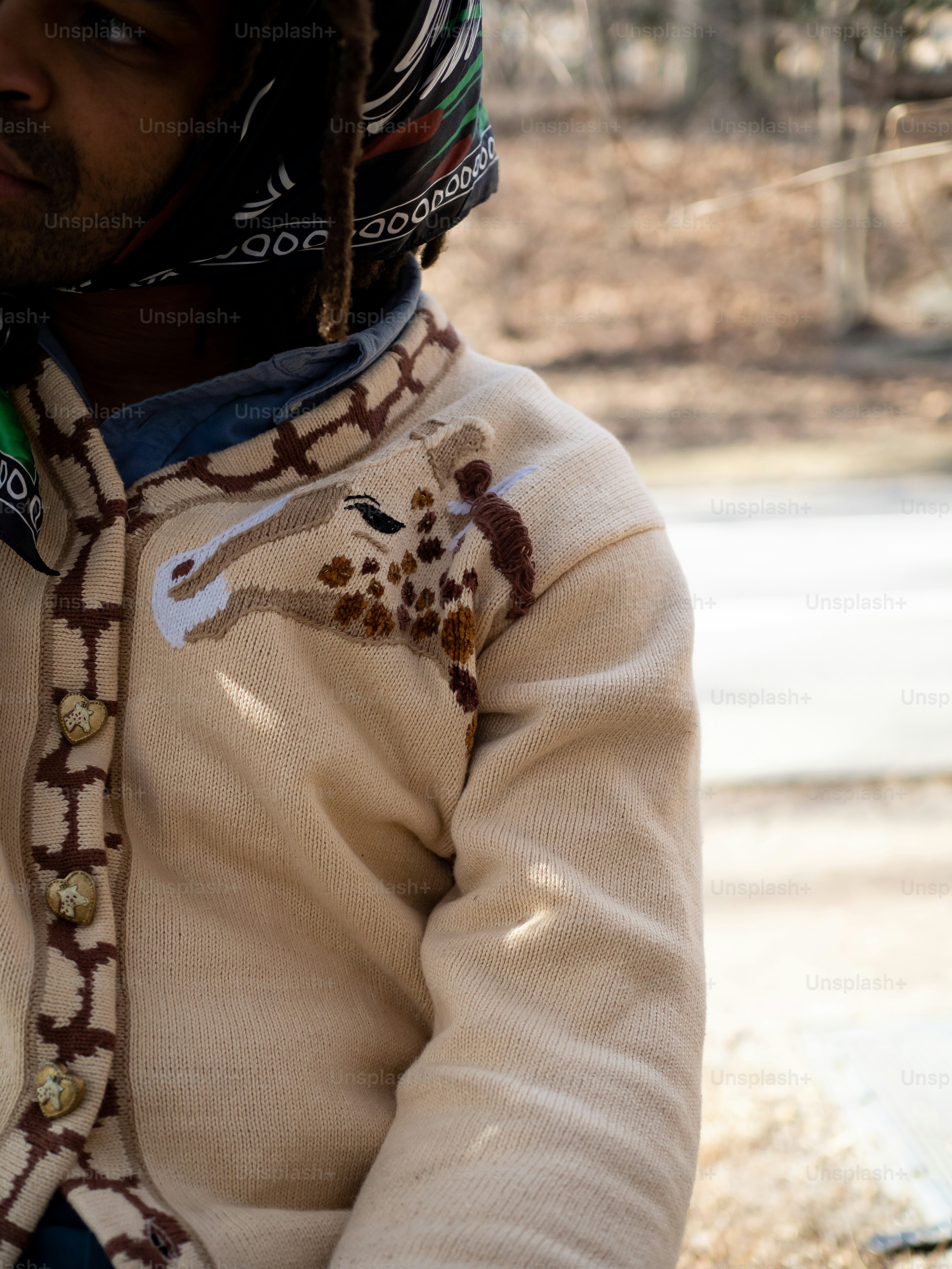 a man wearing a helmet and a sweater