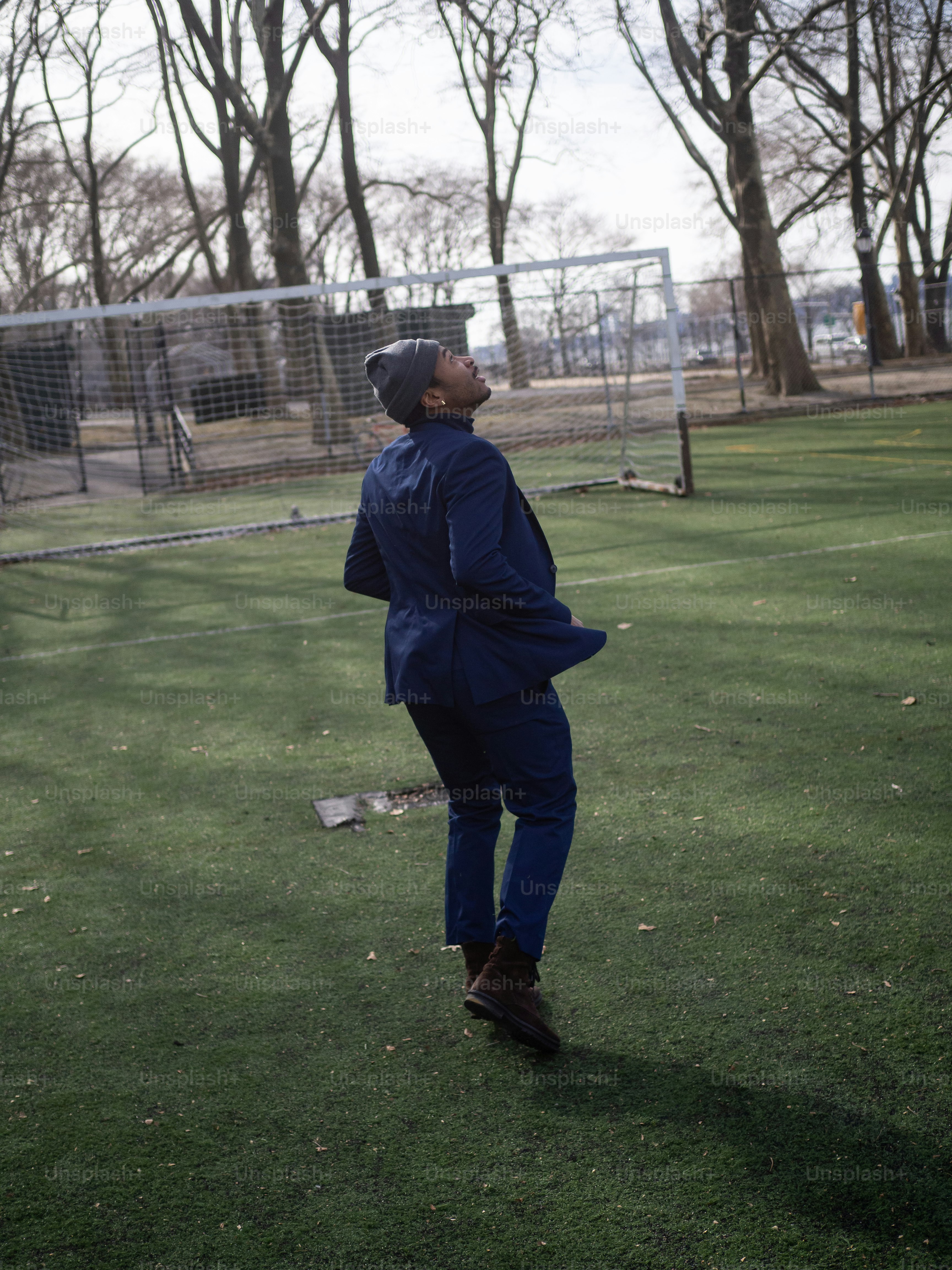 a man standing on top of a lush green field