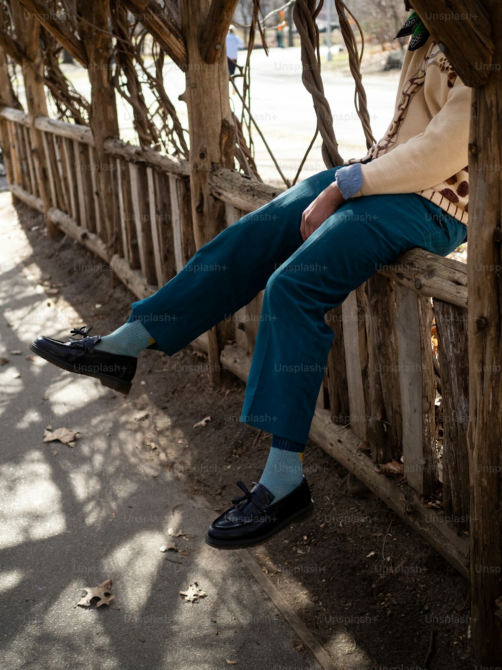 a man is sitting on a wooden bench