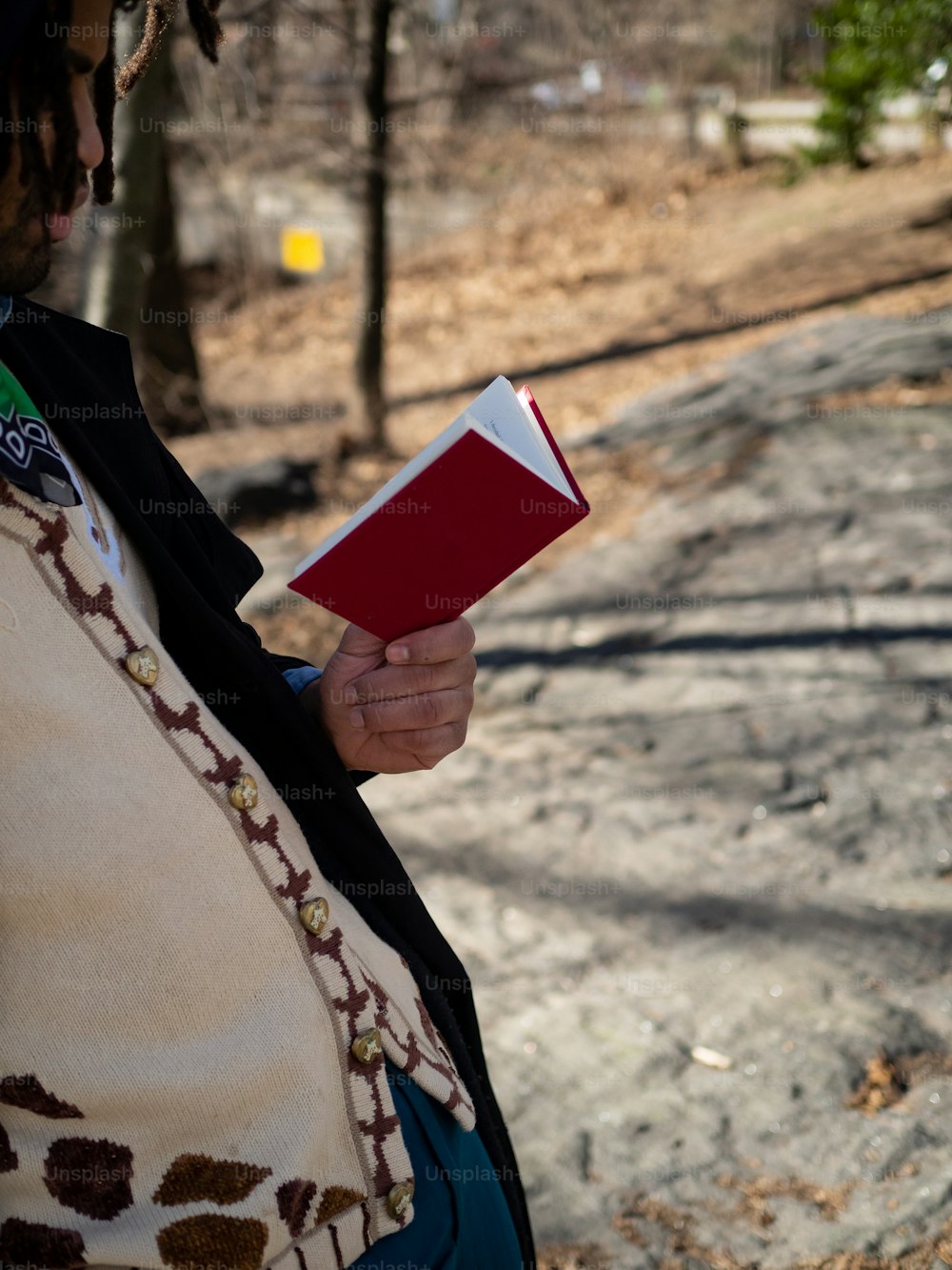 a woman holding a red book in her hands