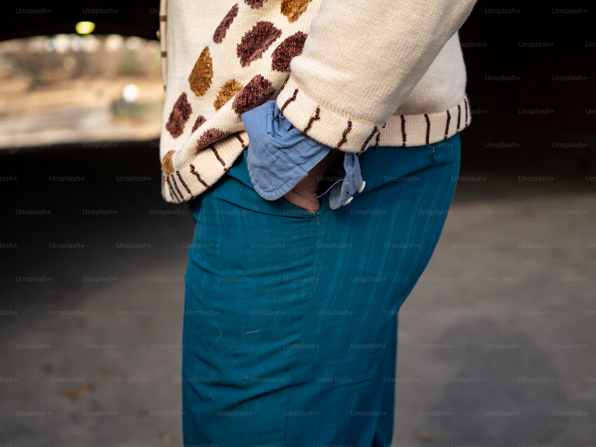 Man wearing a high-quality knit sweater, demonstrating the refined drape and fit of premium natural fiber knitwear