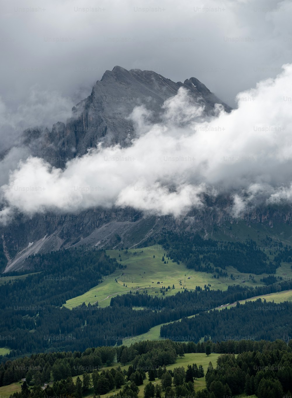 une vue d’une chaîne de montagnes avec des nuages dans le ciel