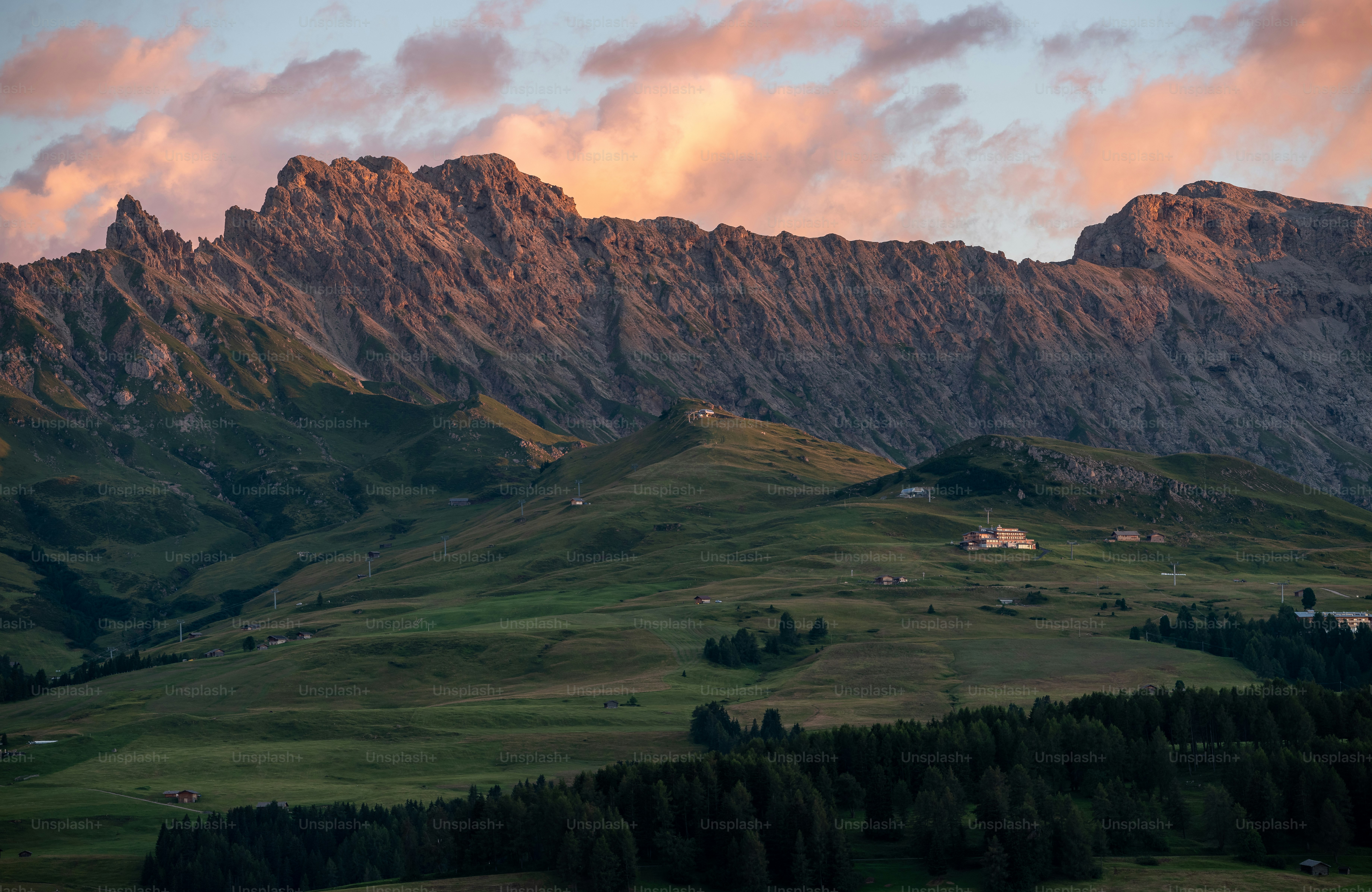 A view of a mountain range with clouds in the sky photo – Mountains ...