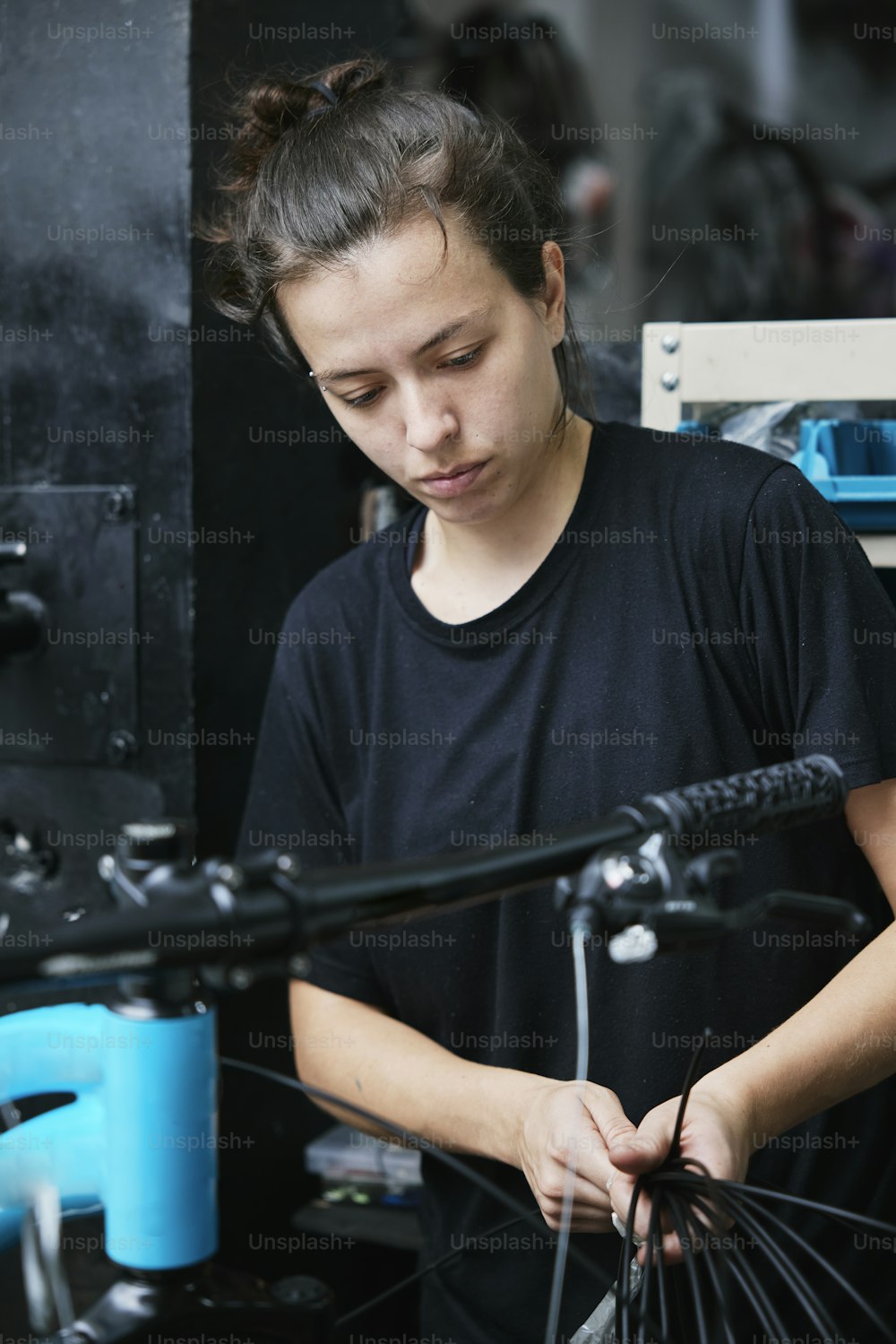 Eine Frau arbeitet an einem Fahrrad in einem Fahrradladen