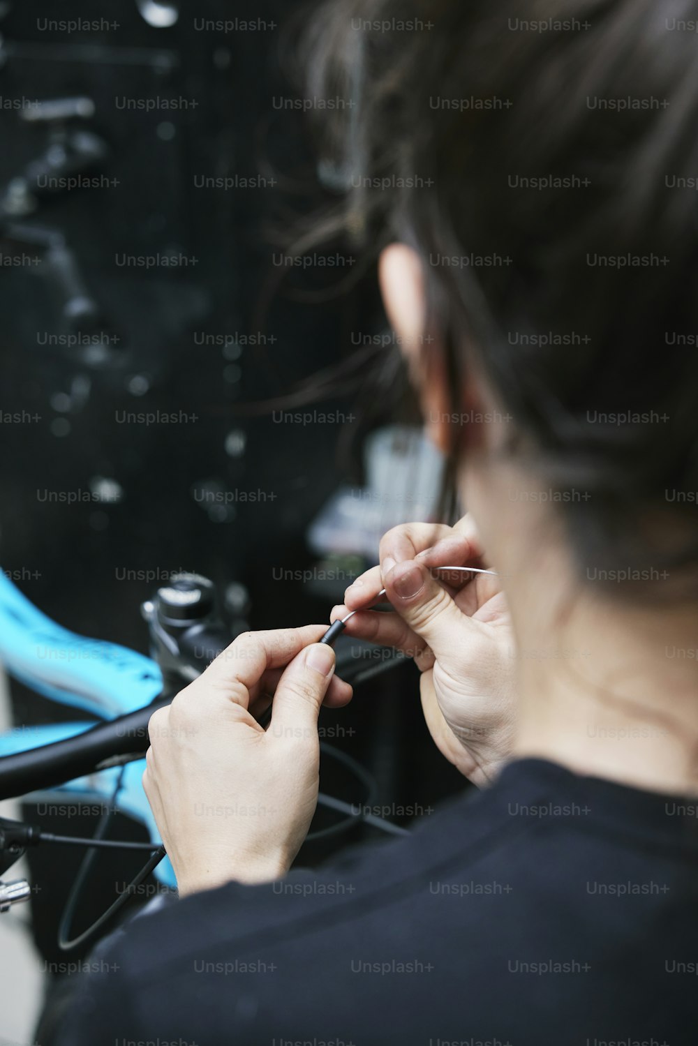 a woman is working on a bicycle wheel