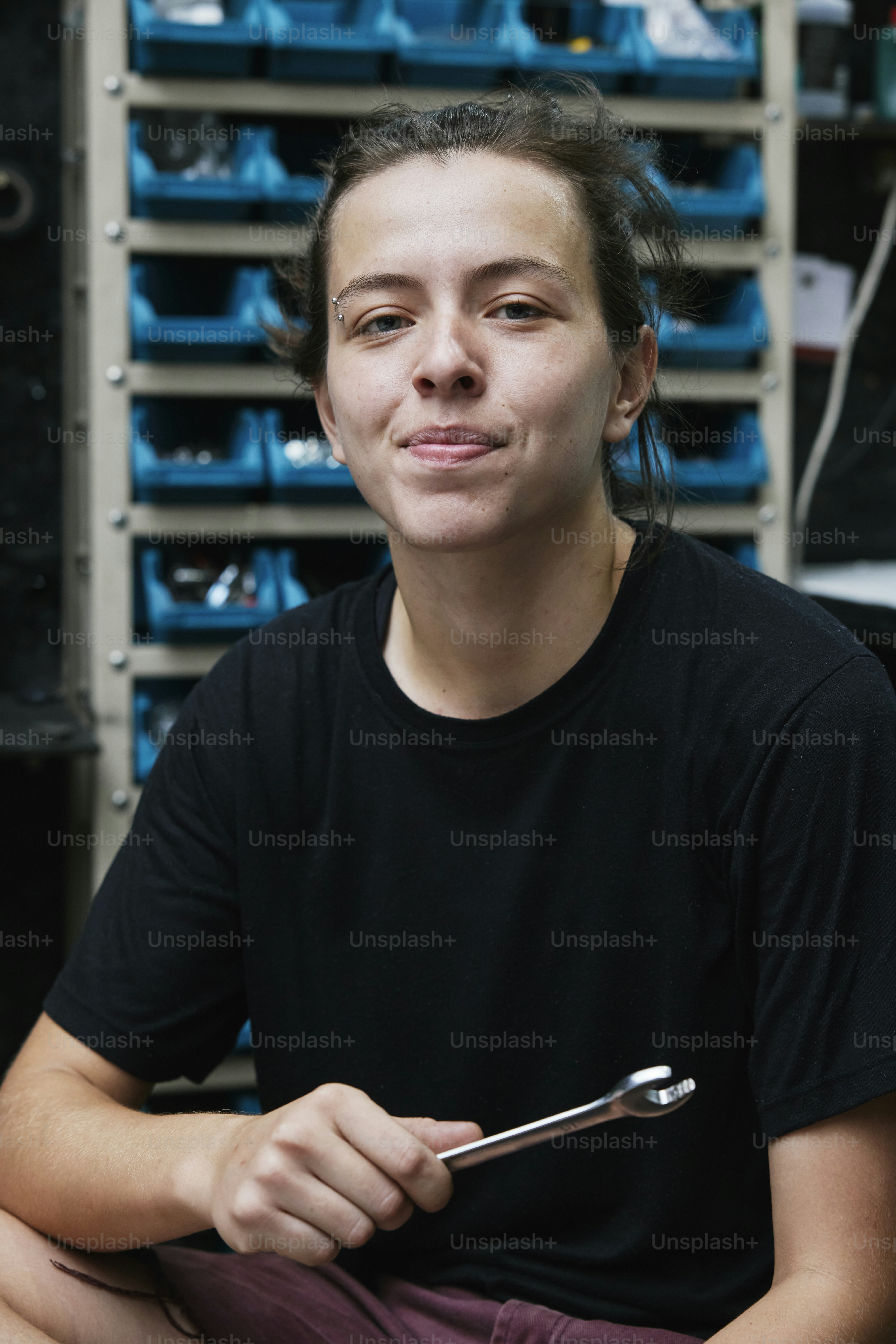 a woman sitting in front of a rack of shoes