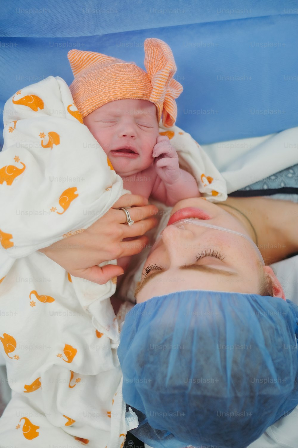 a woman holding a baby in her arms