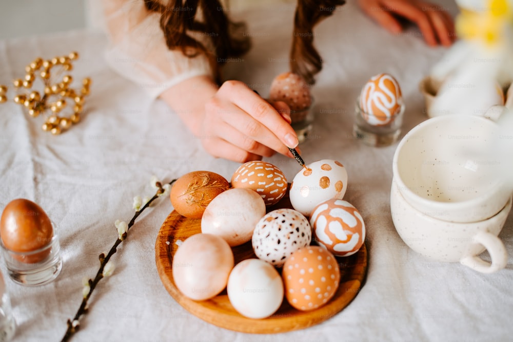 uma mulher é ovos de decoração em uma mesa