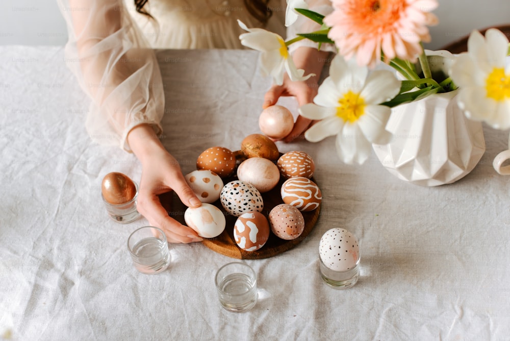 a woman is placing eggs in a bowl on a table