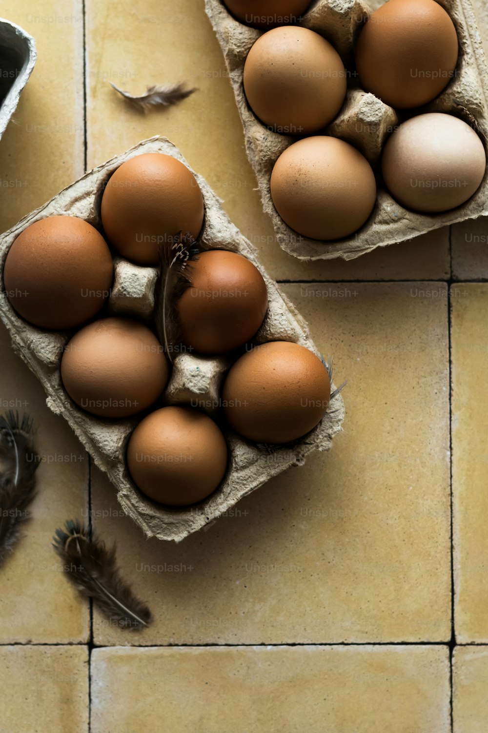 a couple of eggs sitting on top of a tiled floor