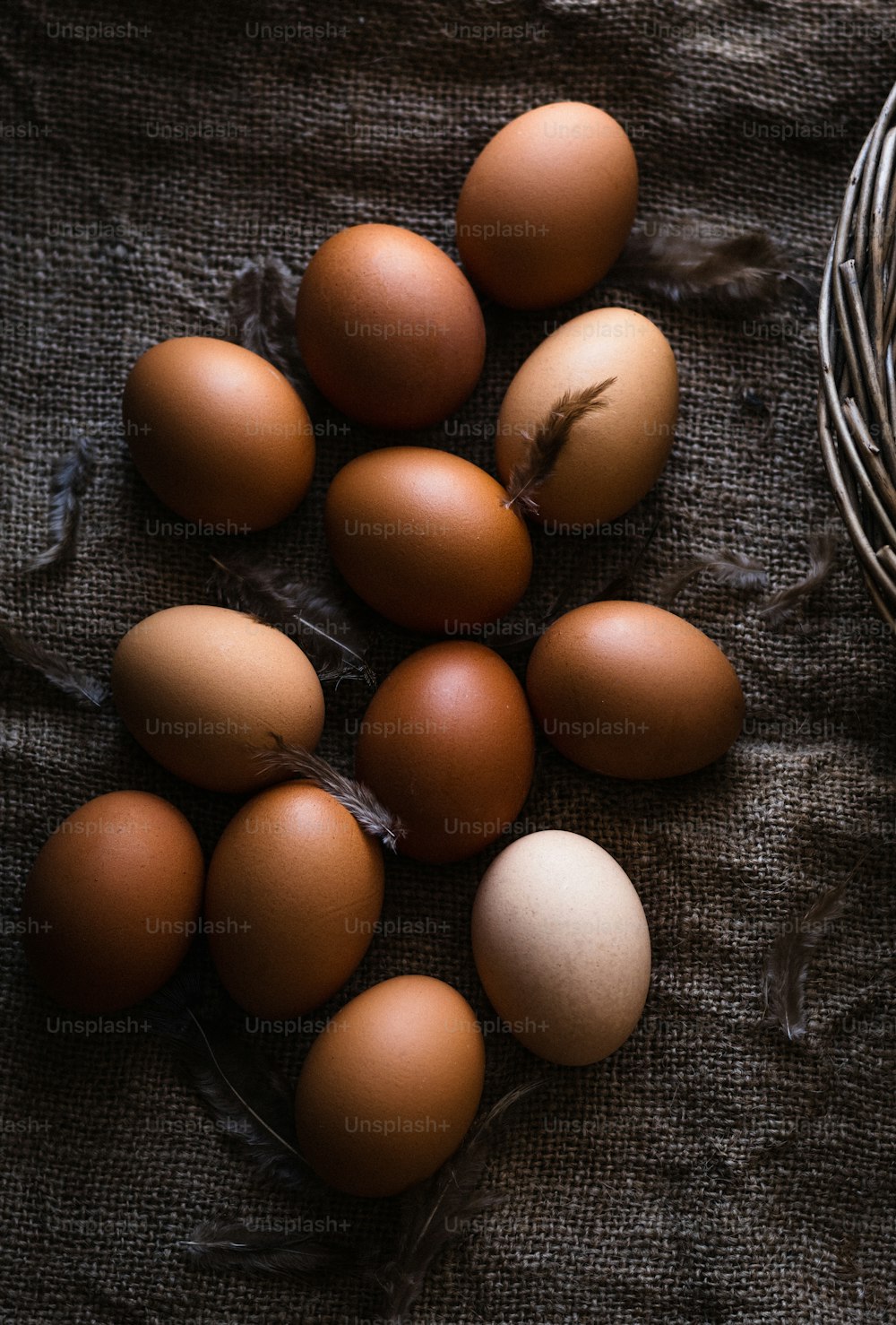 a bunch of brown eggs sitting in a basket
