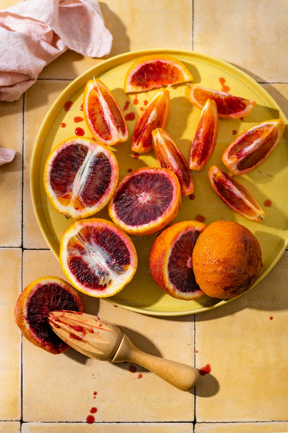 a plate of blood oranges on a table