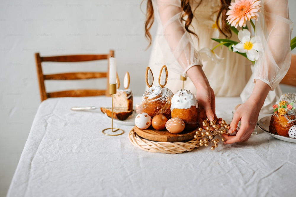 a woman is decorating a basket of food on a table
