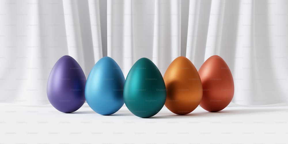 a row of colorful easter eggs in front of a white curtain