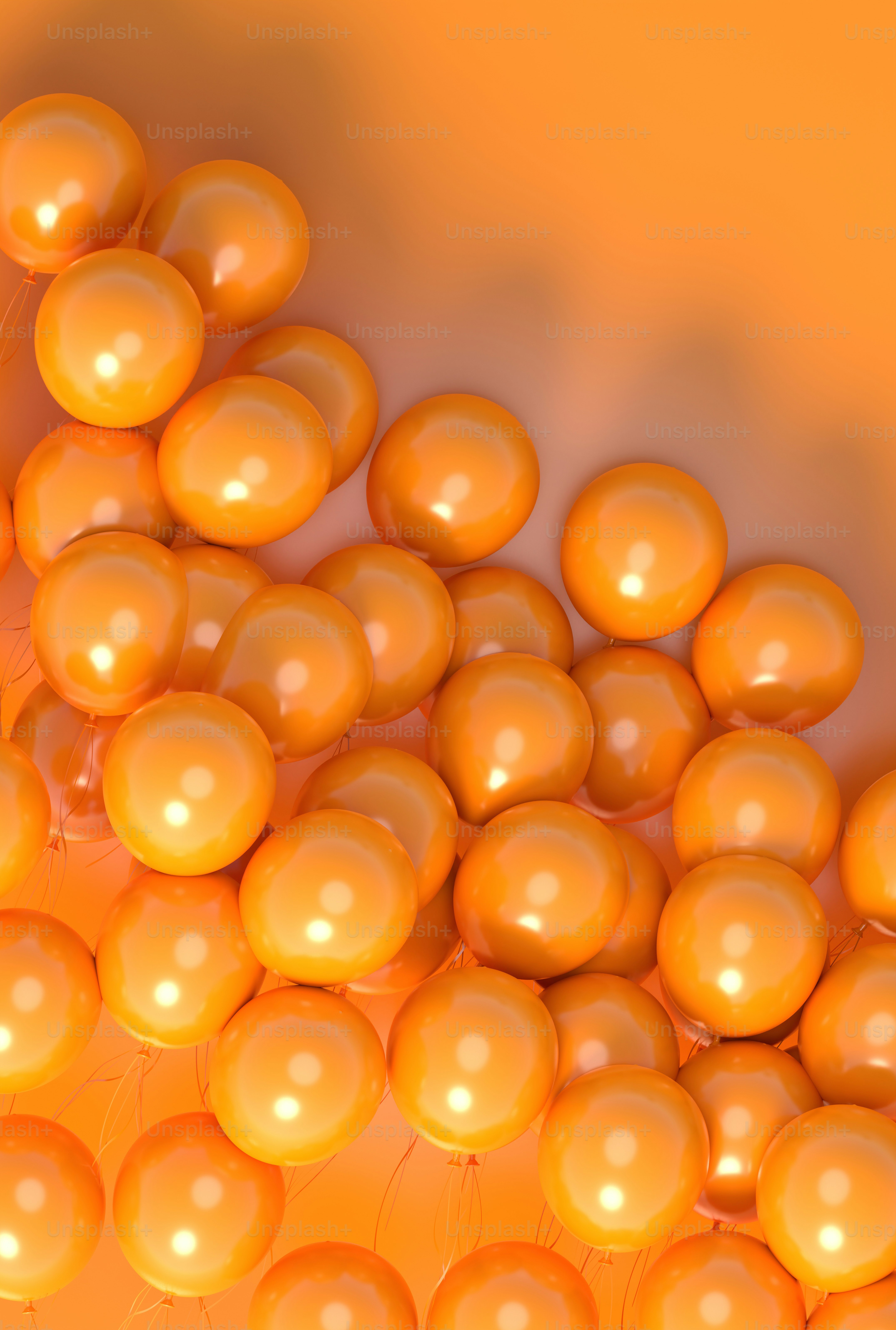a bunch of orange balloons floating in the air