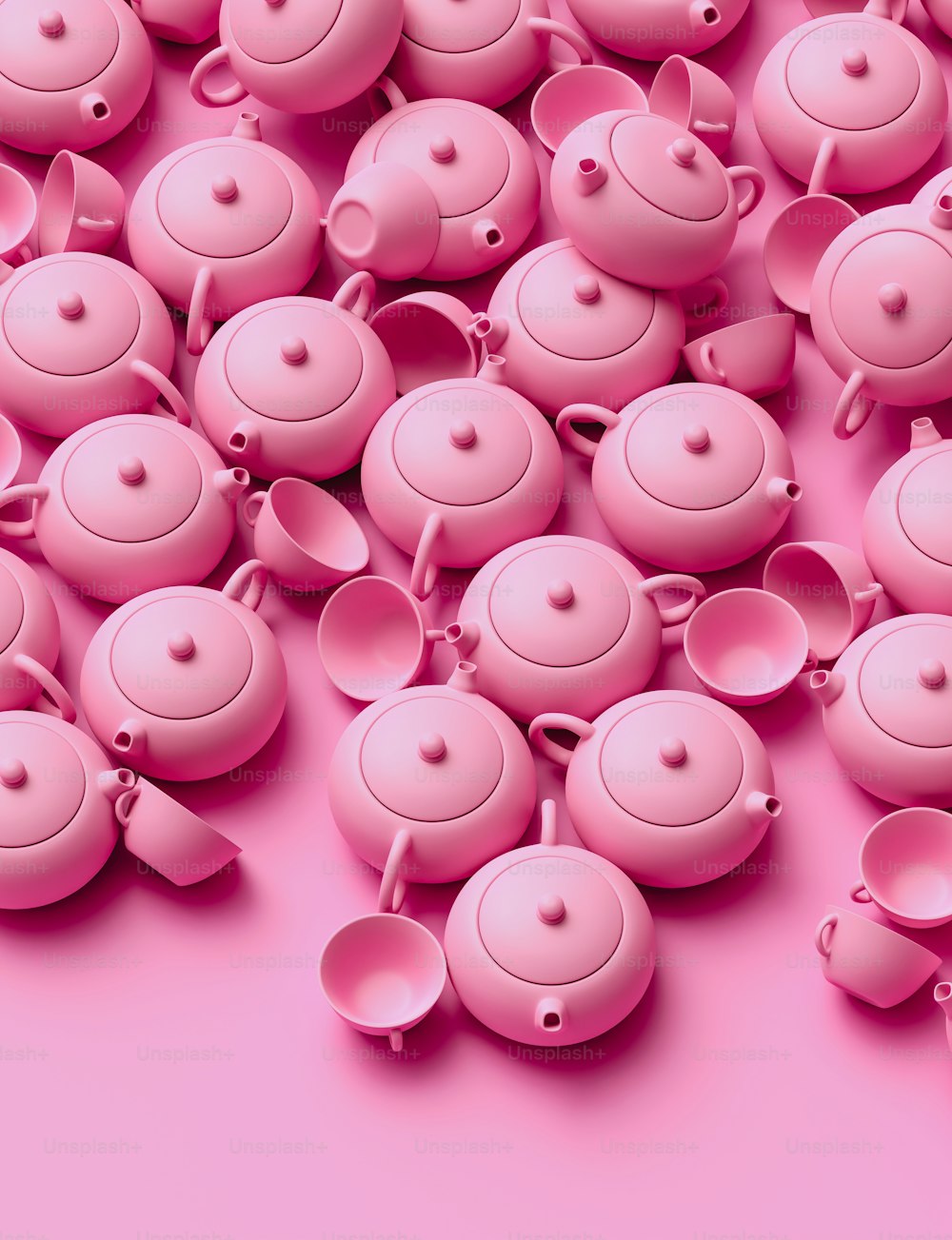 a group of pink teapots sitting on top of a pink surface