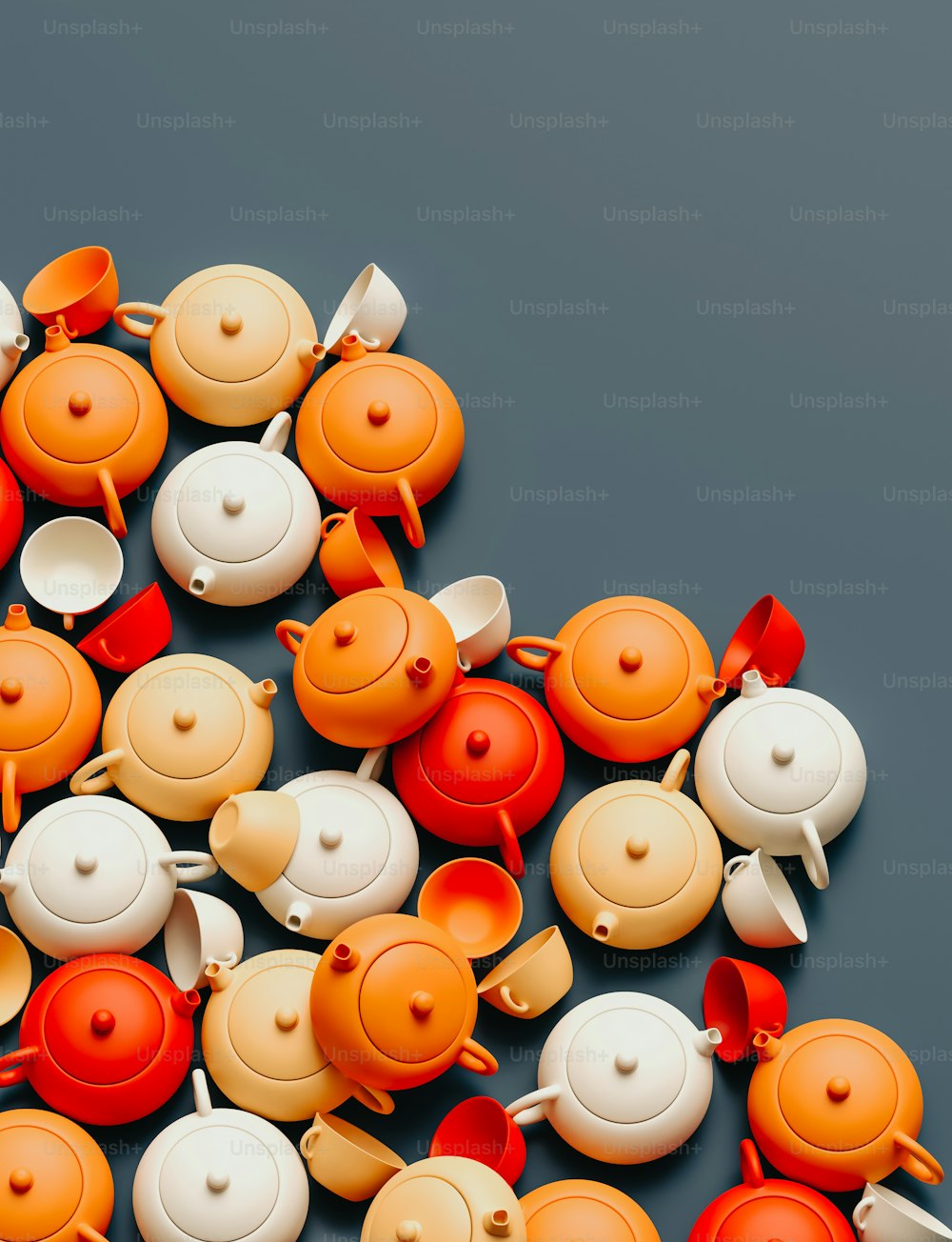 a pile of orange and white teapots on a table