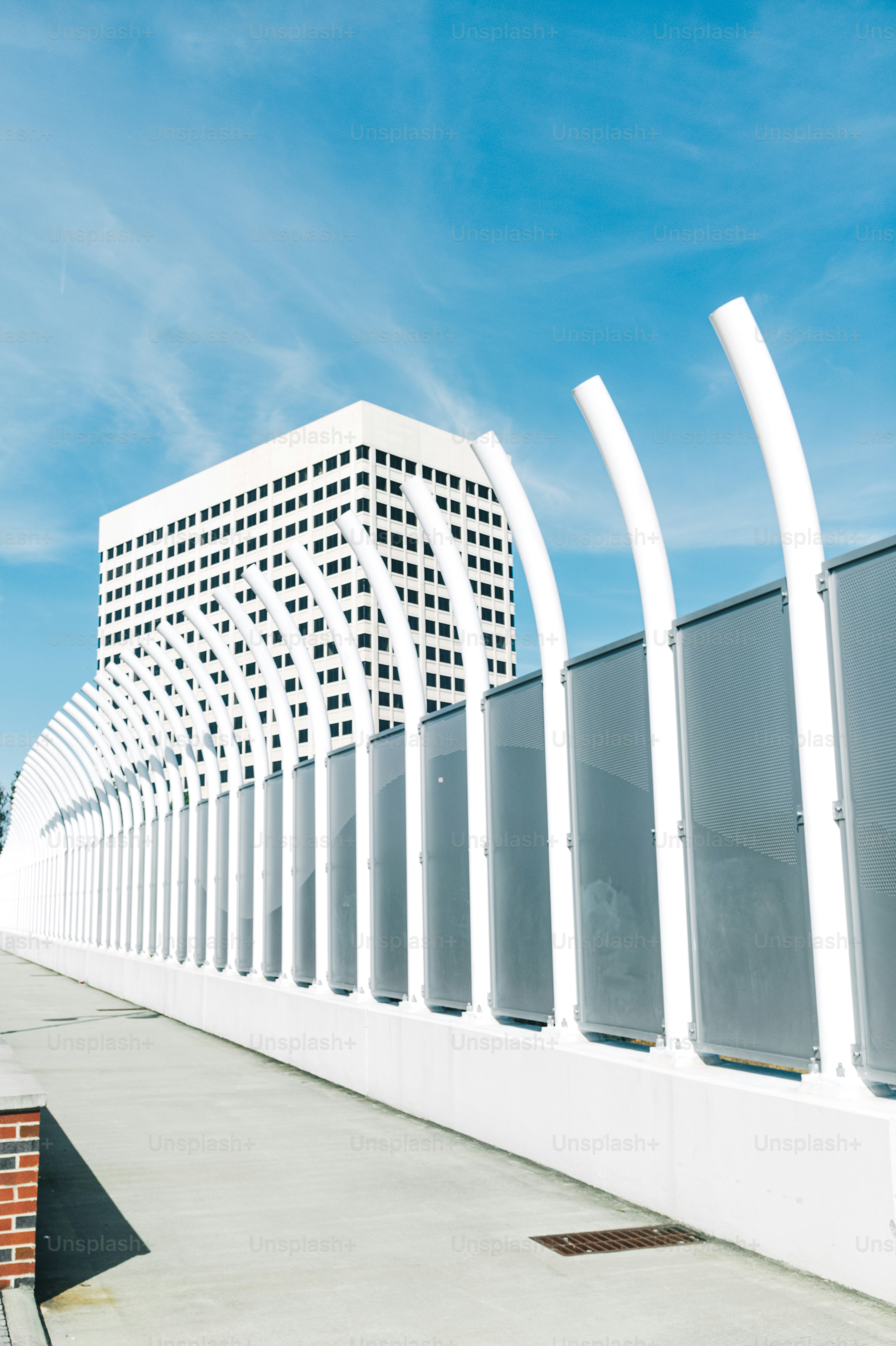 A large white building with a curved roof photo – Bridge Image on Unsplash