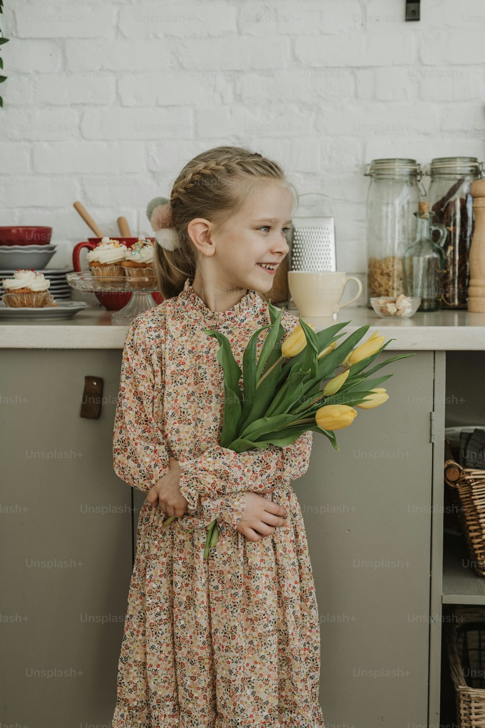 a little girl holding a bouquet of flowers