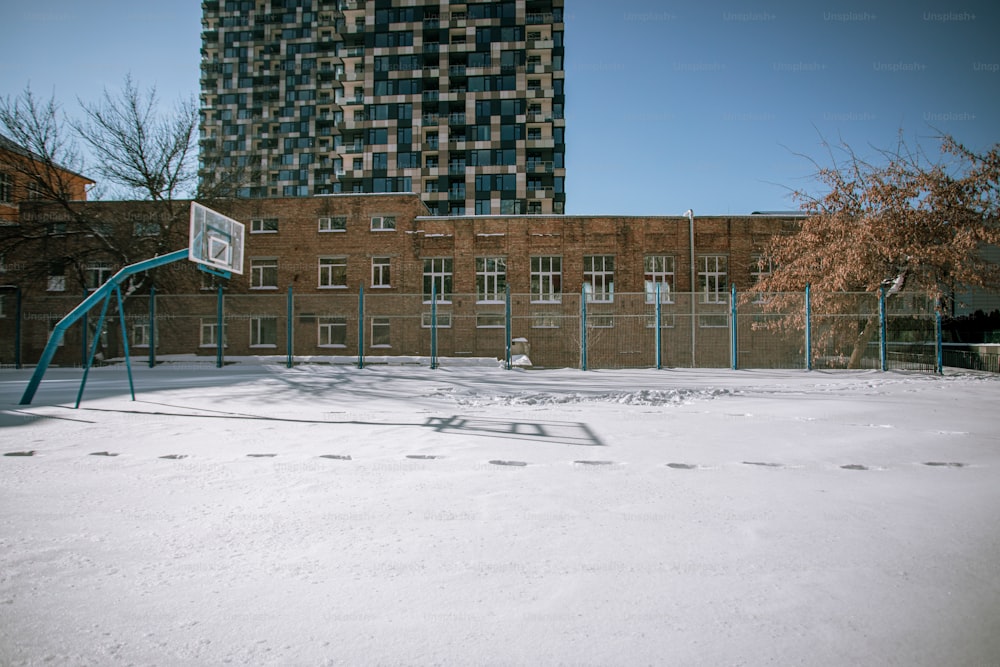 a basketball court with a basketball hoop in the snow