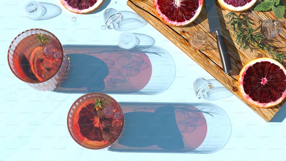 a table topped with glasses of wine and grapefruits