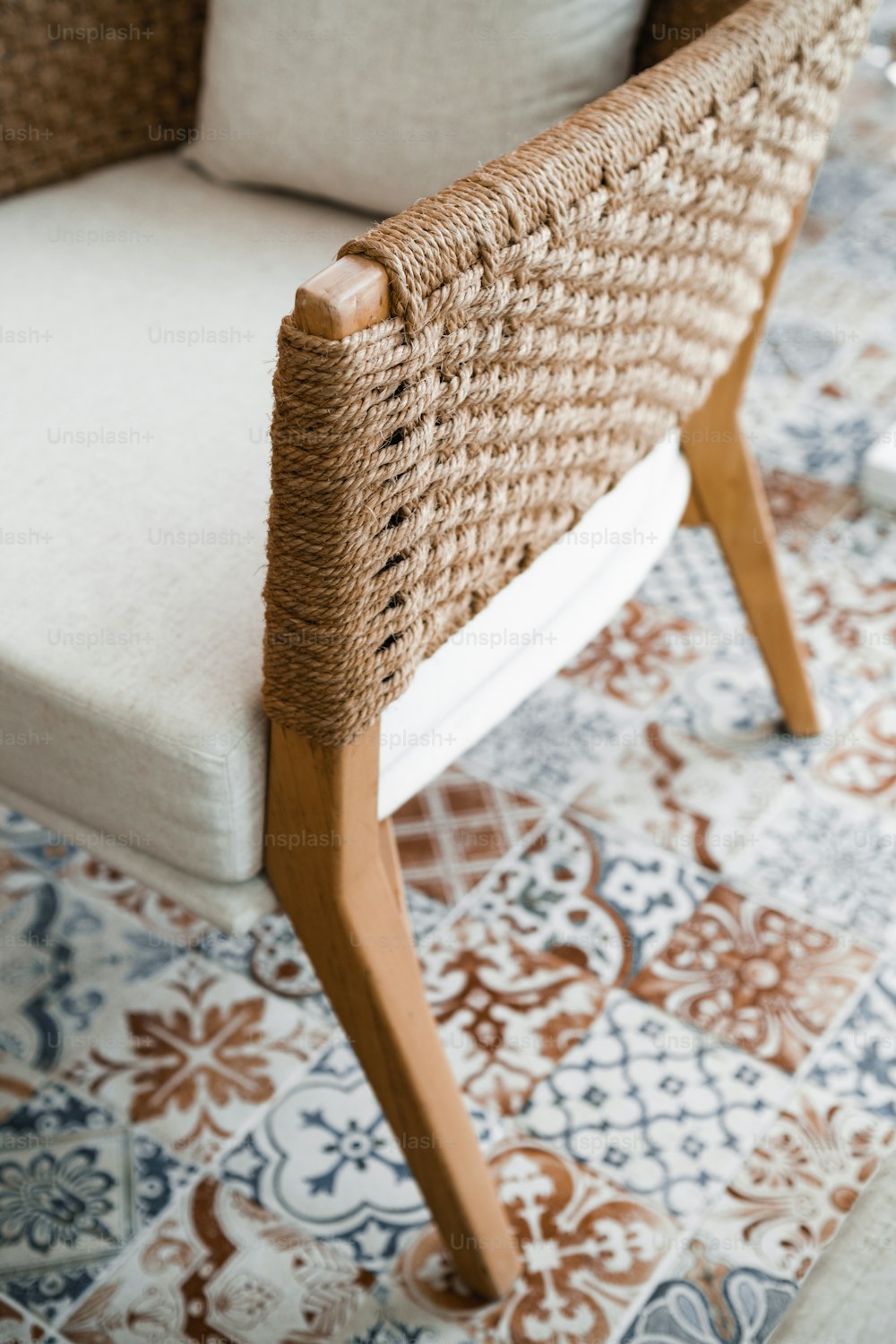 a wicker chair sitting on top of a rug