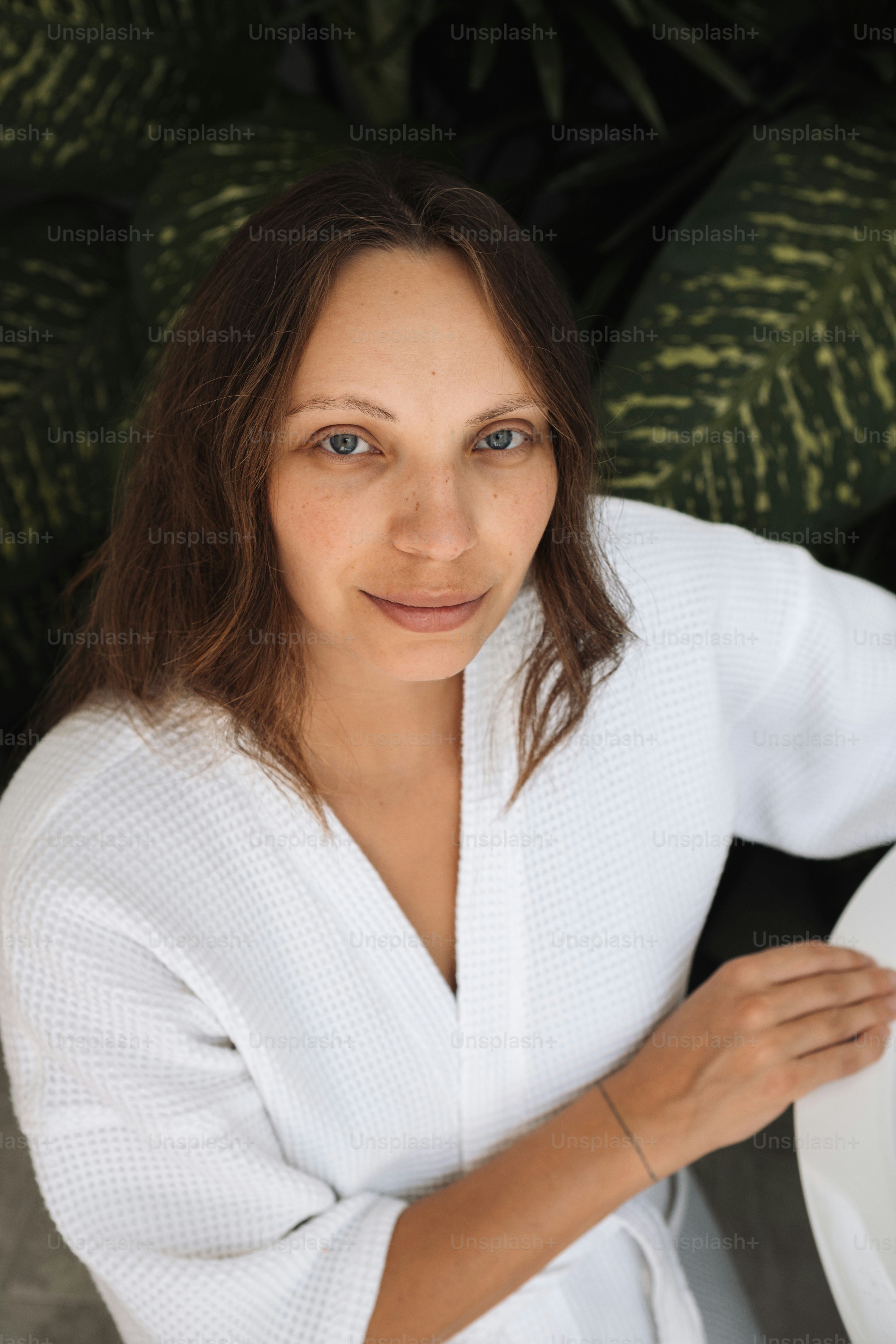 a woman sitting at a table with a plate of food