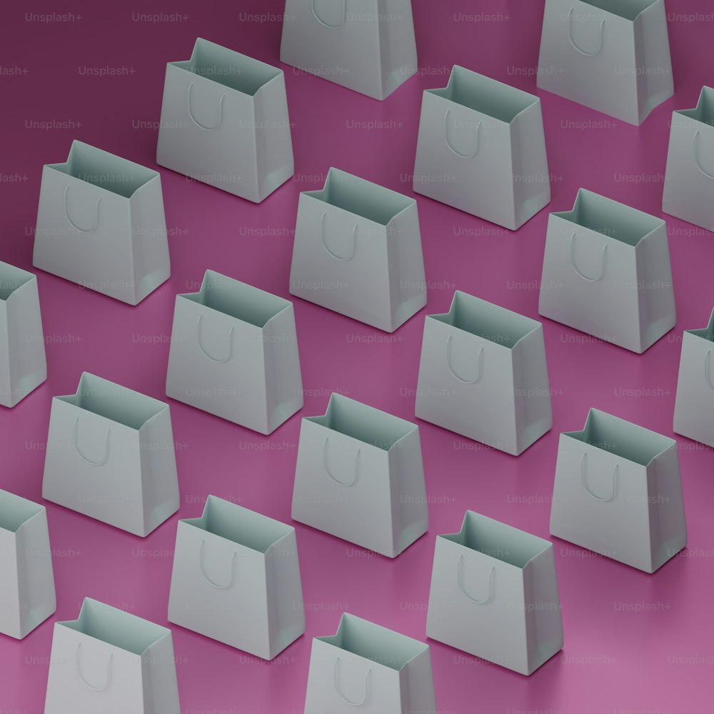 a group of white bags sitting on top of a pink floor