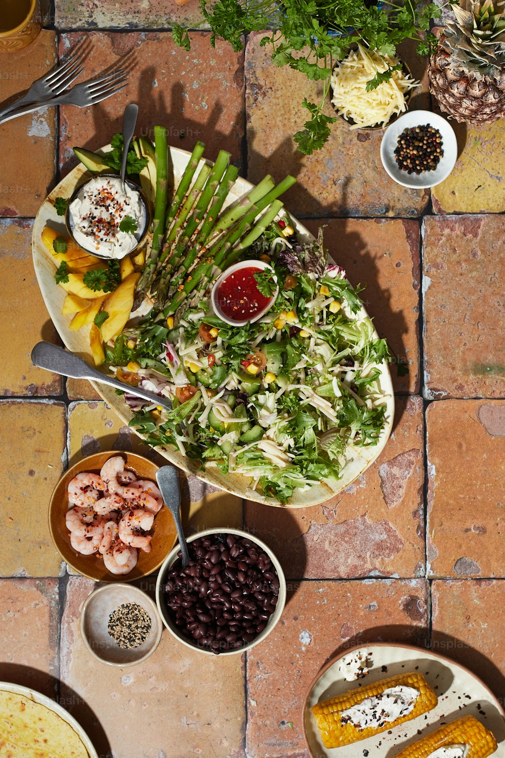 a table topped with plates of food and bowls of food