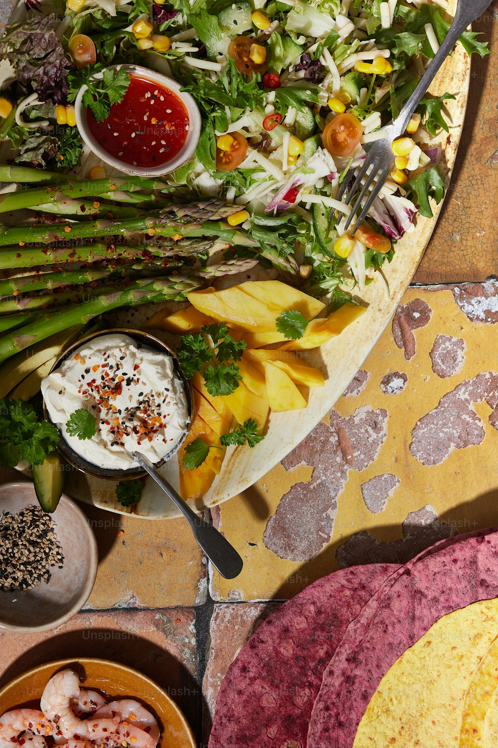 a platter of food with asparagus and other vegetables