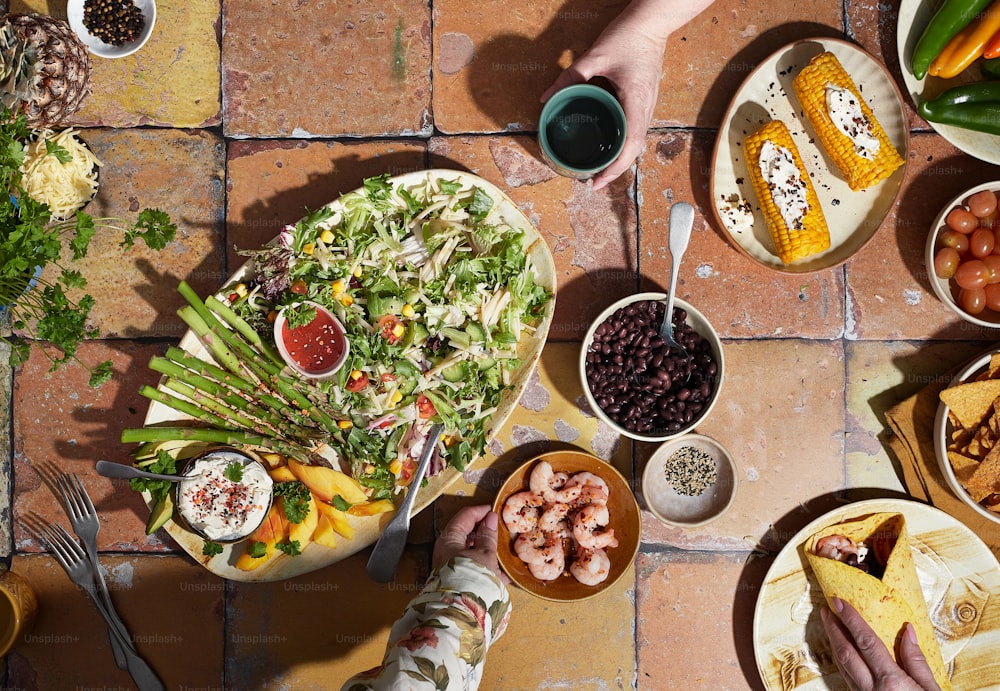 a table topped with plates of food and bowls of vegetables