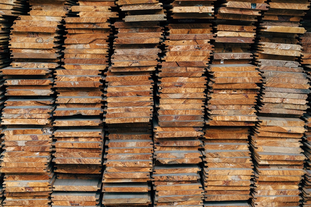 a large stack of wooden planks stacked on top of each other