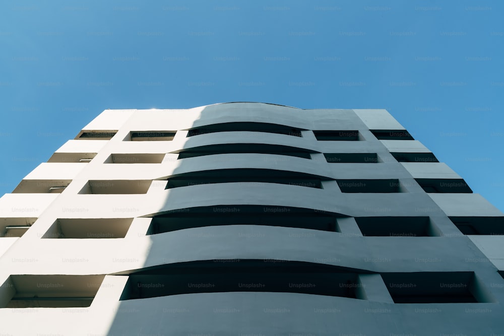 a tall white building with lots of windows