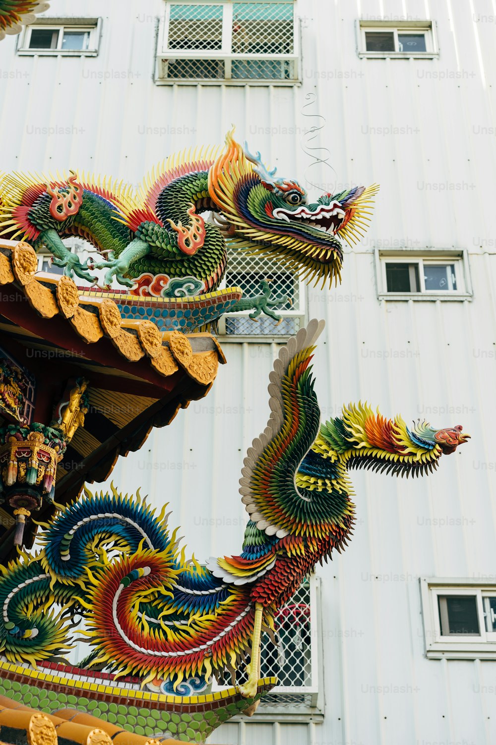 a dragon statue on the side of a building