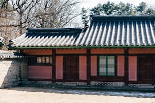 a red building with a green door and window