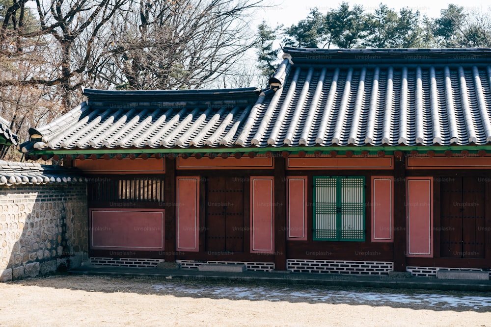 a red building with a green door and window