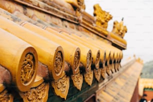 a close up of a yellow roof with ornate designs